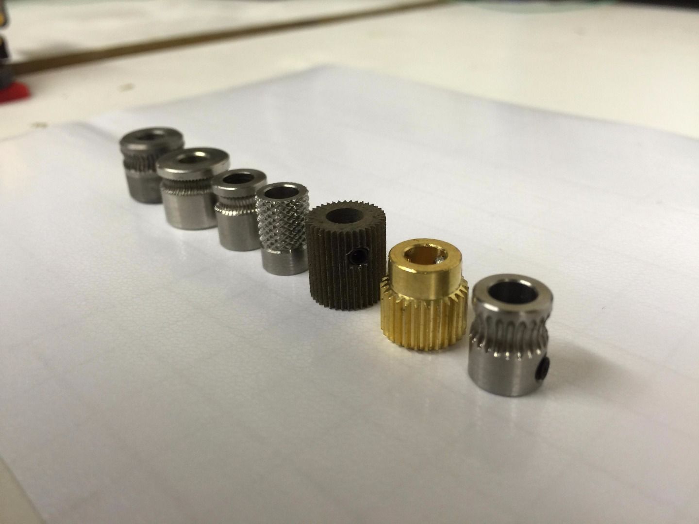 Multiple extruder wheels showing the difference between teeth patterns.