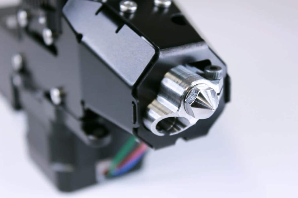 Close-up bottom view of Zephyr™ High Flow Extruder's nozzle, highlighting its precision engineering and robust construction for high-performance 3D printing
